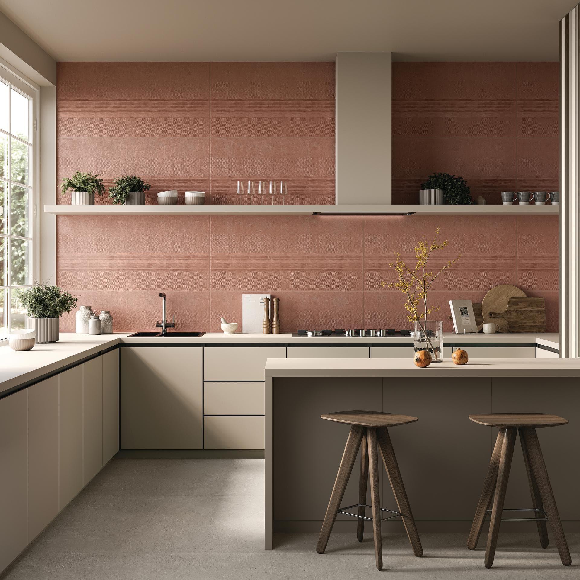 Kitchen with island and pink wall tiling Kitchen with island, glossy pink tiled walls and floor in large matt beige-grey porcelain slabs