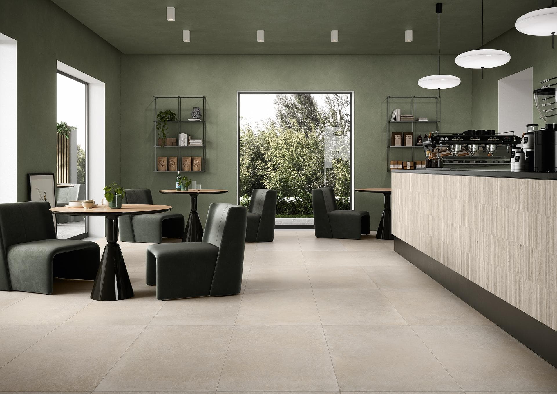 Café with tiled floor and bar counter Café with green walls, dark armchairs, matt almond floor tiles and bar counter clad in beige strips