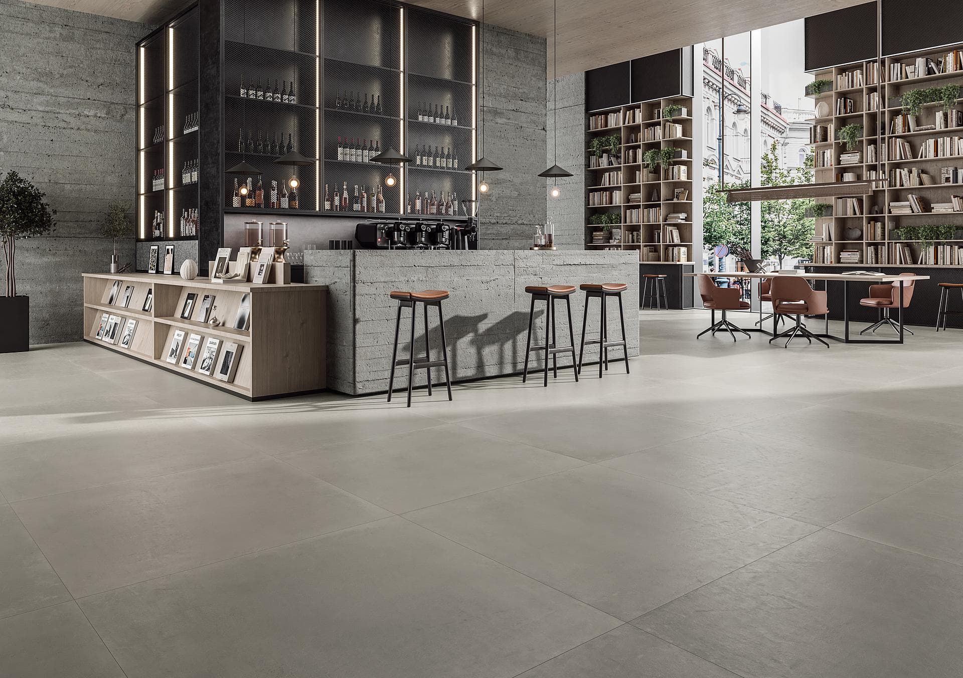 Café bookshop with grey porcelain floor Café bookshop with concrete counter, stools and armchairs on matt grey 120x120 porcelain floor