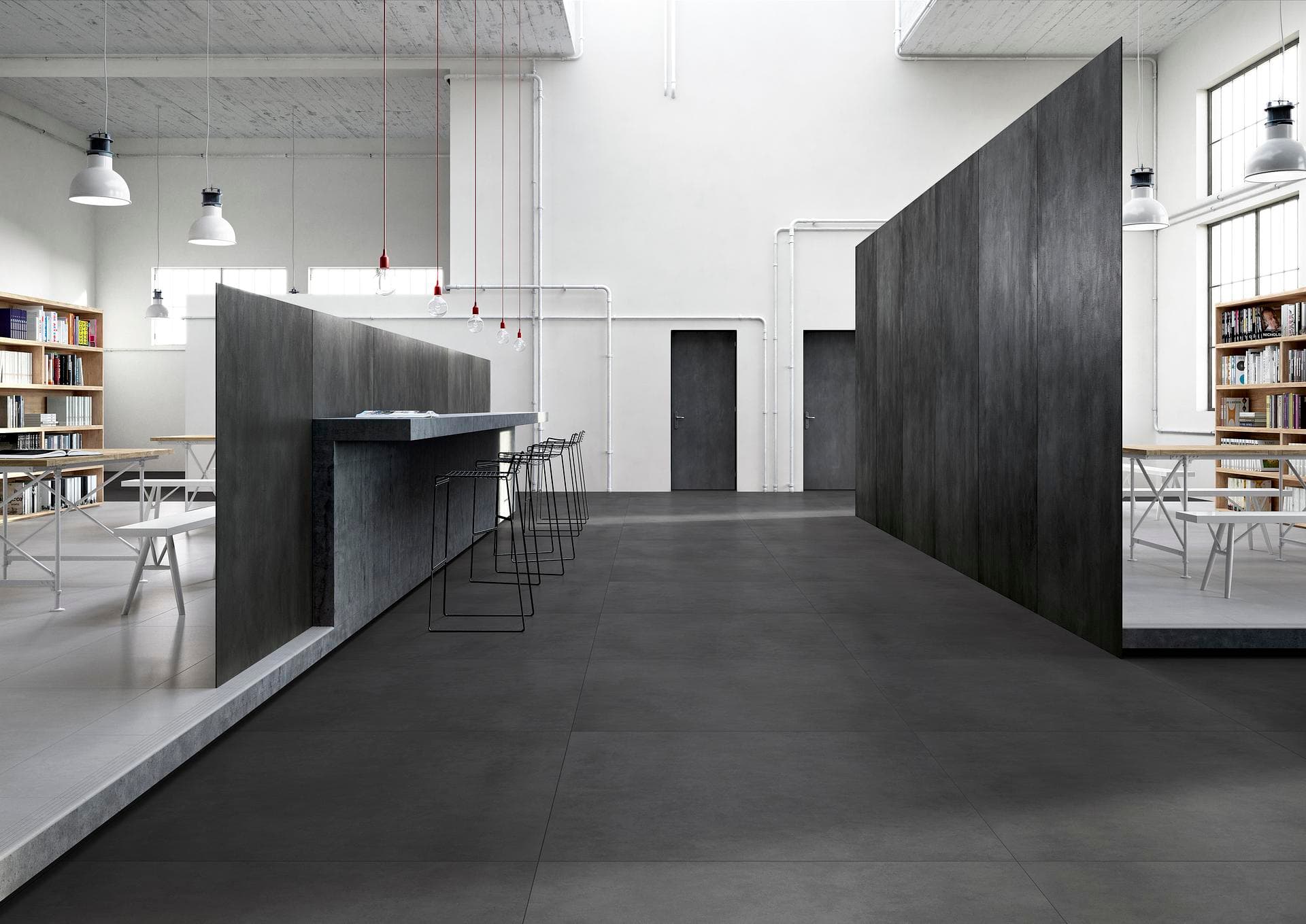 Commercial space with counter and bookshelves Commercial space with counter and dark grey matt porcelain walls, light floor in the side reading areas
