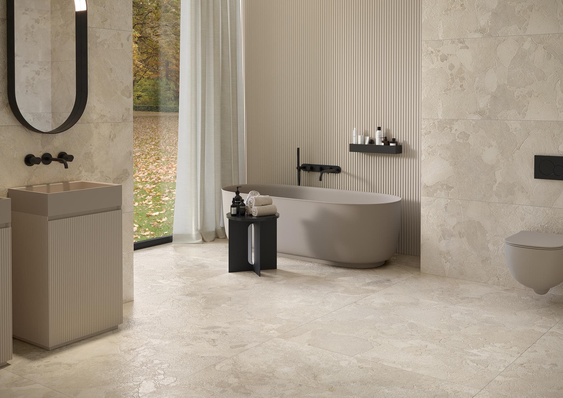 Bathroom with freestanding tub in beige stone effect View the gallery