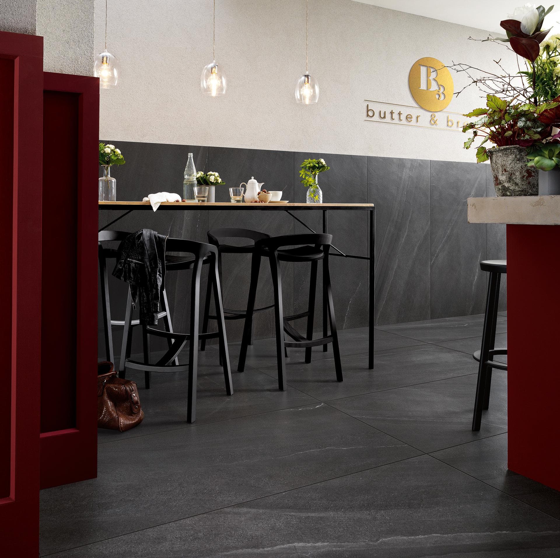 Café with black stone-effect porcelain View the gallery